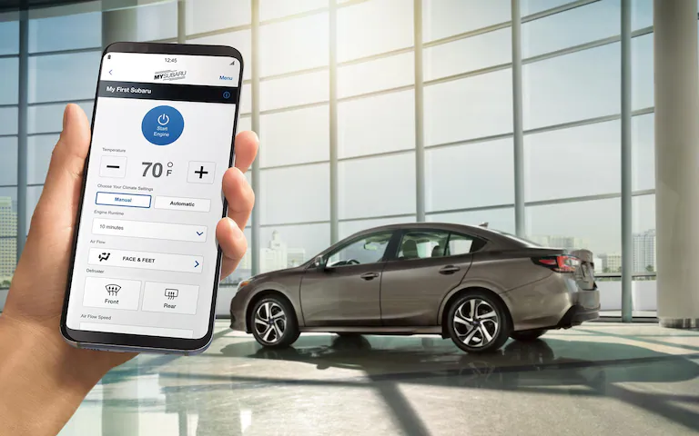 A close-up of a smartphone showing the Remote Engine Start with Climate Control feature available on the 2022 Subaru Legacy.