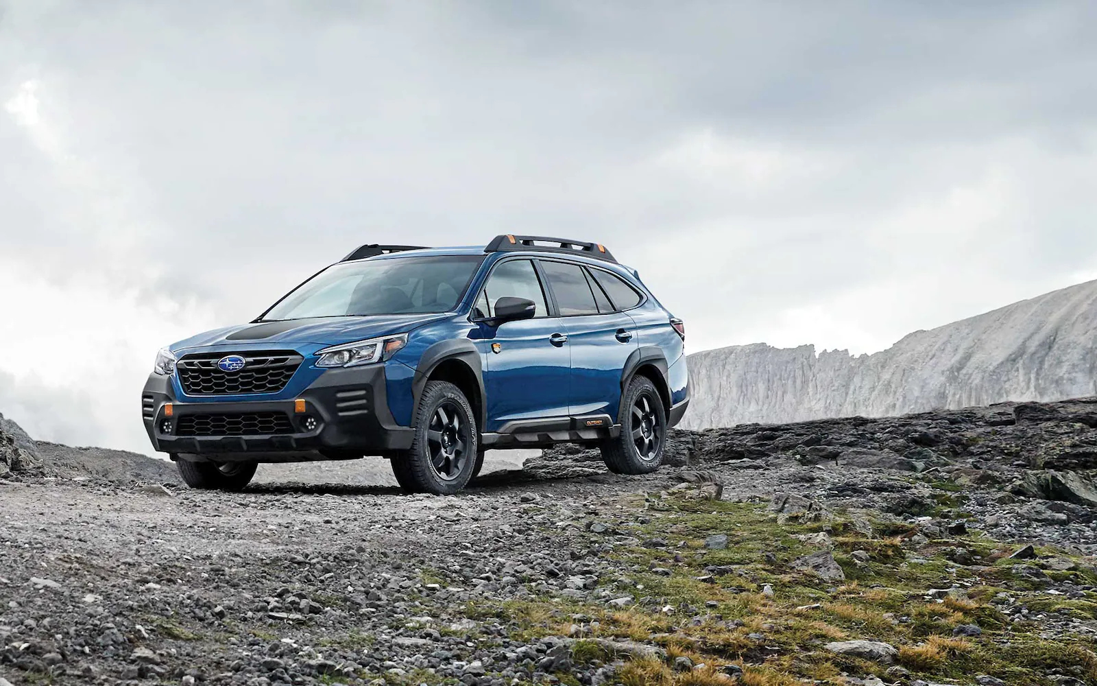 2022 Outback Wilderness in Geyser Blue parked on a rocky road.